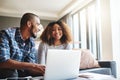 Happy, excited and cheerful couple browsing on laptop and using the internet for payments and calculating home budget Royalty Free Stock Photo