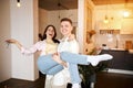 Happy excited cheerful couple celebrating new home,holding keys in hands Royalty Free Stock Photo