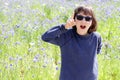 Happy excited child with blue sunglasses expressing playful natural creativity