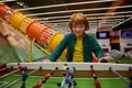 Happy excited child playing table football at entertainment center Royalty Free Stock Photo