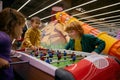 Happy excited children playing table football at entertainment center Royalty Free Stock Photo
