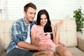 Happy excited couple making positive pregnancy test and celebrating Royalty Free Stock Photo