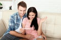 Happy excited couple making positive pregnancy test and celebrating Royalty Free Stock Photo