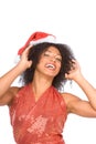 Happy excited ethnic Mrs. Claus in Christmas hat