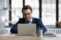 Happy excited financial broker, investor working at laptop