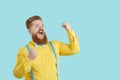 Happy excited funny chubby young man celebrating success, shouting YES and having fun Royalty Free Stock Photo