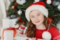 Happy excited girl child holding christmas gift box