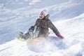 Happy and excited girl Sledding downhill on a snowy day Royalty Free Stock Photo