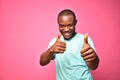 happy and excited handsome young black man giving thumbs up with both hands