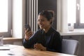Happy excited Indian woman using smartphone for video call