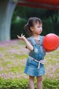 Happy excited joyful girl cute child smile laugh play colorful balloon have fun at summer park nature happiness childhood Royalty Free Stock Photo