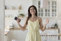 Happy excited Latin teenage girl dancing to music at home Royalty Free Stock Photo