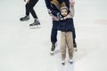 Happy little boy and his mother learning ice-skating Royalty Free Stock Photo