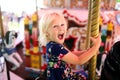 Happy Excited Little Girl Riding the Carousel at a Carnival Royalty Free Stock Photo