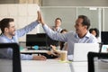 Happy excited male colleagues giving high five at work