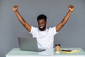 Happy excited man celebrate his success. Winner, black man in office reading on laptop, copy space Royalty Free Stock Photo