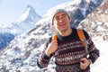 Happy excited man enjoying backpacking in mountains in winter