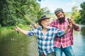 Happy excited man friends. Portrait of cheerful senior man fishing. Grandfather and son fishermans. Young man and an old Royalty Free Stock Photo