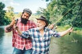 Happy excited man friends. Portrait of cheerful senior man fishing. Grandfather and son fishermans. Young man and an old