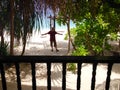 Happy excited man standing front beachfront chalet tropical island resort