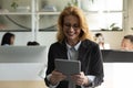 Happy excited mature business woman using online app on tablet Royalty Free Stock Photo