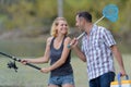 Happy excited man and woman fishing on pond