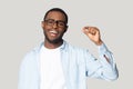 Happy excited millennial african american guy showing small prices gesture.