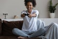 Happy excited millennial Black girl playing video game at home Royalty Free Stock Photo