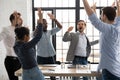 Happy excited millennial employees shouting for joy