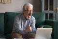 Happy excited old man reading good news looking at laptop Royalty Free Stock Photo