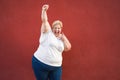 Happy and excited plus size woman celebrating with success and winning gesture - Focus on face Royalty Free Stock Photo