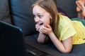 Happy excited preteen girl chatting online using laptop for video call. Royalty Free Stock Photo