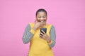 happy and excited pretty african lady viewing content on her mobile phone looking surprised