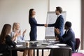 Happy excited promoted employee shaking hands with boss