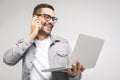 Happy excited smiling young man holding laptop and raising his arm up to celebrate success or achievement. White background Royalty Free Stock Photo