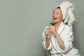 Happy excited spa model woman taking a shower and singing on gray background Royalty Free Stock Photo