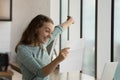 Happy excited student girl reading paper letter with good news,