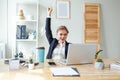 Happy excited successful businesswoman triumphing with laptop in office Royalty Free Stock Photo