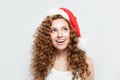 Happy excited surprised young woman in Santa hat smiling. Christmas and New Year party portrait Royalty Free Stock Photo