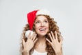 Happy excited surprised young woman in Santa hat smiling. Christmas and New Year party portrait Royalty Free Stock Photo