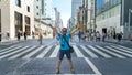 Happy and excited tourist at shopping district Ginza with famous Chuo Dori street, Tokyo, Japan