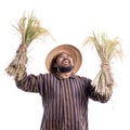 Happy excited traditional farmer with hand raised holding rice