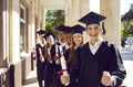 Happy excited university graduates rejoice in successful completion of their studies. Royalty Free Stock Photo