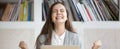 Happy woman sitting at workplace celebrating great opportunity at work