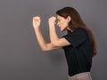 Happy excited woman doing spyglass sign looking in by fingers the hands with surprising opened mouth in black t-shirt. Concept Royalty Free Stock Photo