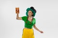 Happy excited woman in green yellow football kit holding beer mug and football ball supports favorite team. Soccer fans Royalty Free Stock Photo