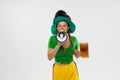 Happy excited woman in green yellow football kit holding beer mug and football ball supports favorite team. Soccer fans Royalty Free Stock Photo