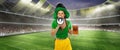 Happy excited woman in green yellow football kit holding beer mug and shouting at megaphone supports favorite team Royalty Free Stock Photo