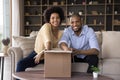 Happy excited young African couple receiving parcel Royalty Free Stock Photo