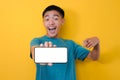 Happy Excited Young Asian man shock pointing blank phone screen for copy space and showing white phone screen at camera Royalty Free Stock Photo